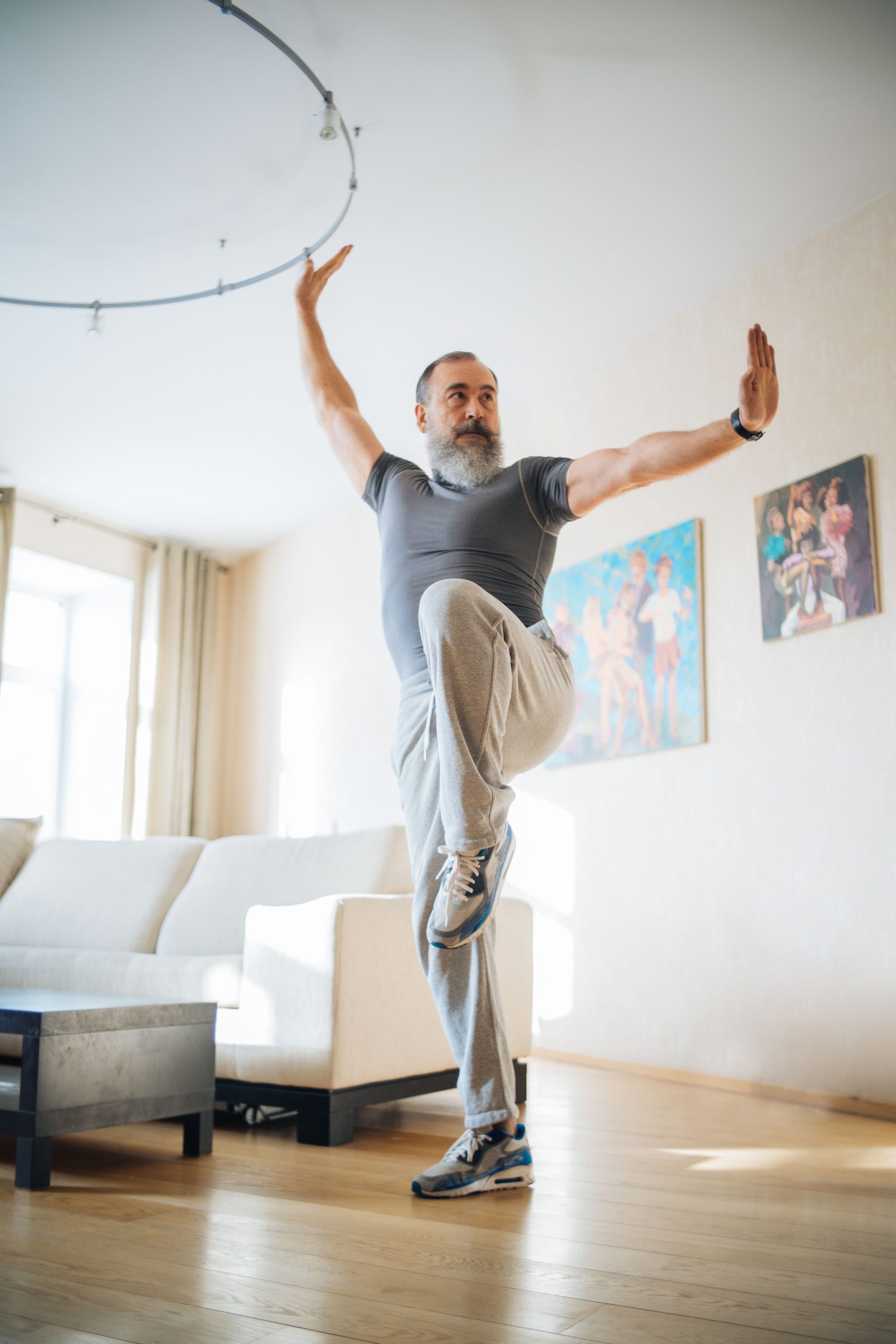 Elderly man engaging in fitness routine indoors, promoting wellness and healthy living.